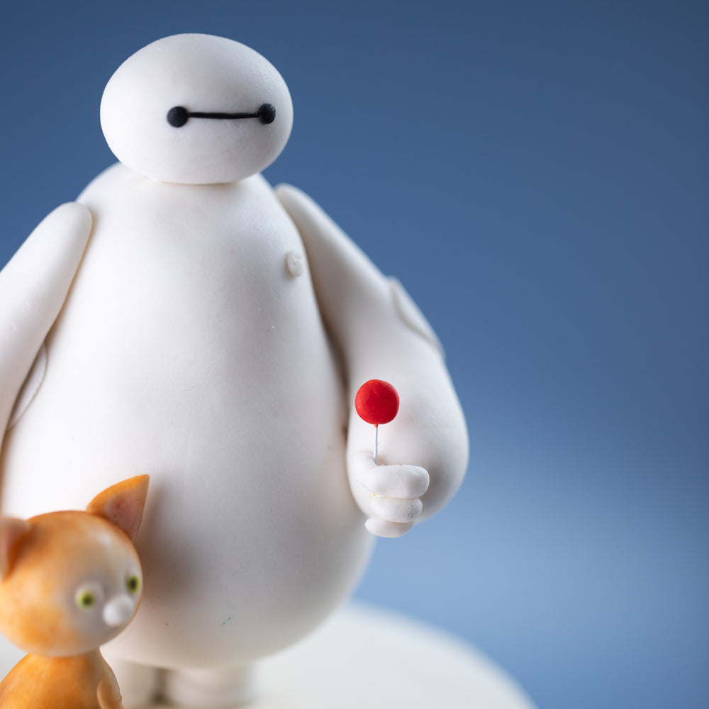 A close up on the 3D fondant Baymax, and the red lolipop that he is holding.