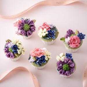 
                  
                    Load image into Gallery viewer, 6 cupcakes with assorted hand piped buttercream flowers in vibrant pink, purple, blue and ivory. There are sugar pearls lightly sprinkled on top. The flowers look incredibly realistic and beautiful.
                  
                