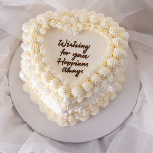 
                  
                    Load image into Gallery viewer, A beautiful white buttercream heart shaped cake with vintage baroque styled buttercream piping. The buttercream is white, giving the cake an elegant, princess-y feel. The cake is extremely beautiful.
                  
                