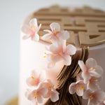 A close up of the light pink sugar plum blossoms. They are intricate and look incredibly realistic.