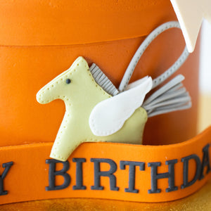 
                  
                    Load image into Gallery viewer, A close up to one of the decorations. This fondant piece looks like the Hermes horse keychain in light green.
                  
                