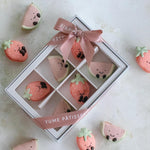 A white box with a transparent window. Inside the box there are assorted macarons that look like jellycat watermelon and strawberry plushies. The macarons are super cute.