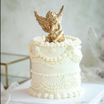 White vintage buttercream birthday cake Singapore with gold cherub chocolate topper